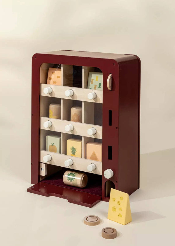 The Wooden Play Vending Machine encourages pretend play with knobs, compartments, and food-themed blocks like cheese and fruit. Ideal for developing motor skills, this toy features a neutral design to fit any playroom.