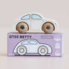A classic white wooden No. 9 GT55 Betty car rests atop a purple box marked “Made in England.” The packaging highlights a nostalgic illustration of the toy alongside icons for sustainable wood, English craftsmanship, and child-safe paint—promising endless imaginative fun.