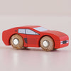 The No. 25 GT140 Marco, made in England, is a small red wooden racing car with black windows and silver axle details, shown on a light surface, capturing the charm of a classic motorsport toy.