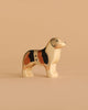 The Handmade Holzwald Australian Shepherd is a small, hand-painted wooden toy dog with brown, black, and white markings—perfect for imaginative play or as a charming, sustainable addition to any toy collection.