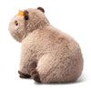 The Steiff Chip Capybara is a plush toy with light brown fur, darker brown feet and ears, and a small yellow rectangle on its left ear, shown sitting on a white background.