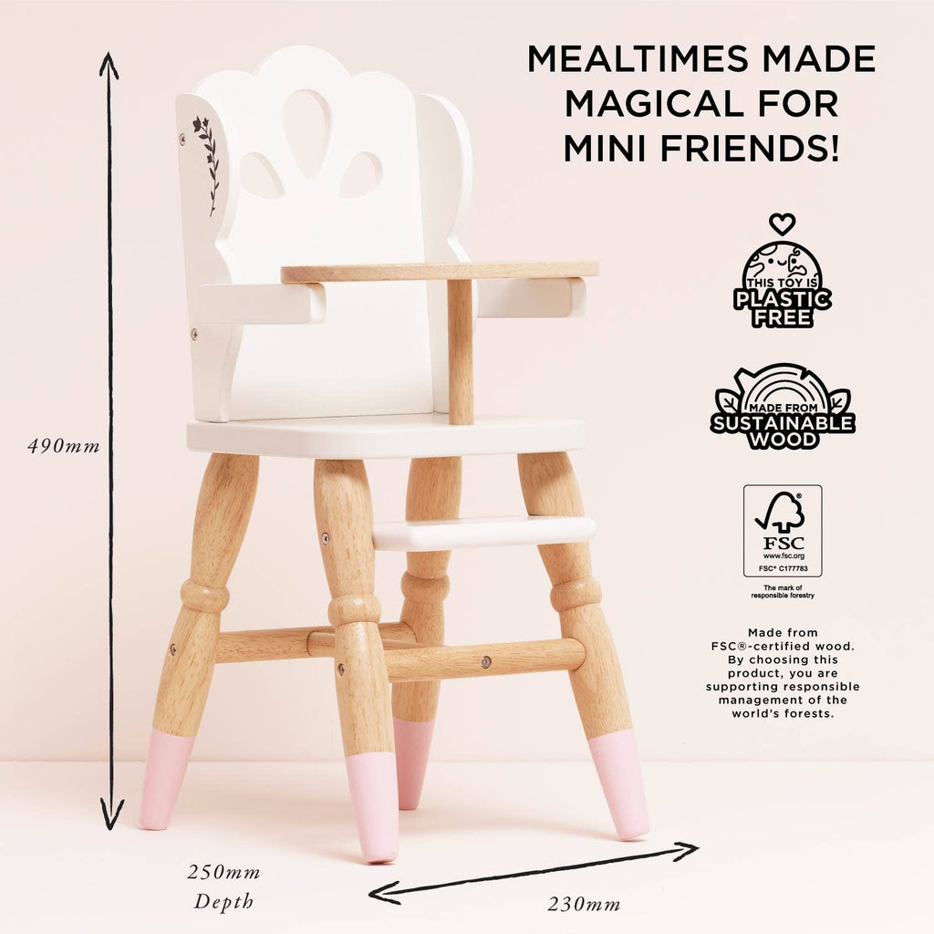The Dolls Wooden High Chair is plastic-free and sustainably made, featuring white and natural wood with pink-tipped legs, a decorative backrest, and ideal for pretend play. Dimensions: 490mm high, 250mm deep, 230mm wide.