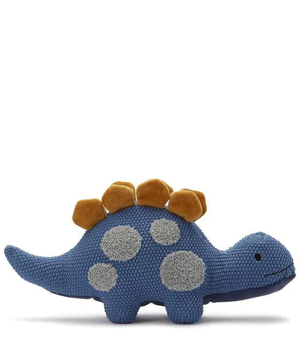 The Stegosaurus Dinosaur Stuffed Animal is a blue knitted plush toy with grey spots on its body and yellow ridges along its back. Featuring a simple facial expression with small stitched eyes and a mouth, this adorable product stands against a white background. It is machine washable and can be tumble dried for easy care.