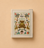 The Storybook Embroidered Small Photo Album features a beige bookcloth cover with embroidered animals, trees, a swan, flowers, and alphabet blocks in a decorative folk-art style on a plain tan background, and holds up to 48 photos.