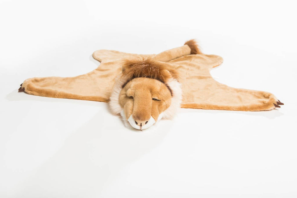 The Costume - Lion is a plush lion rug made of soft faux fur, featuring an attached lion head with a calm face, mane, and tail. It lays flat on a white background and showcases the lion’s closed eyes and gentle smile.