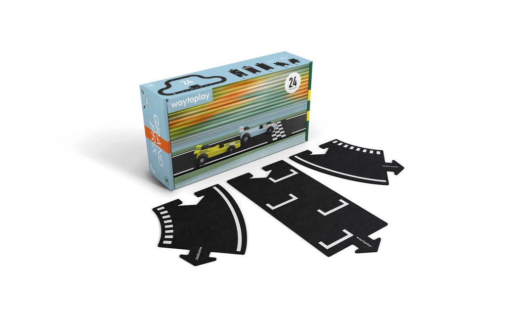 A "Large Flexible Toy Race Track - Grand Prix" boxed set includes 24 flexible road pieces, shown beside four black puzzle-like track segments with white markings. The box displays a race car and checkered flag illustration.