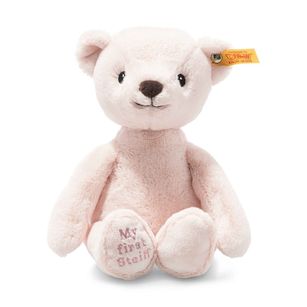 The My First Steiff Pink Teddy Bear, 10 Inches, is a soft, baby-safe teddy with a light pink color, friendly face, yellow Steiff ear tag, and "My first Steiff" embroidered on one paw.