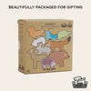 A cardboard box labeled "Woodland Stacking Forest Animals & Bag" is adorned with vibrant illustrations of woodland creatures from this charming stacking set. The text states "Beautifully packaged for gifting" and "100% recyclable packaging." This eco-friendly toy, featuring wooden animal blocks, is suitable for children aged 18 months and up.