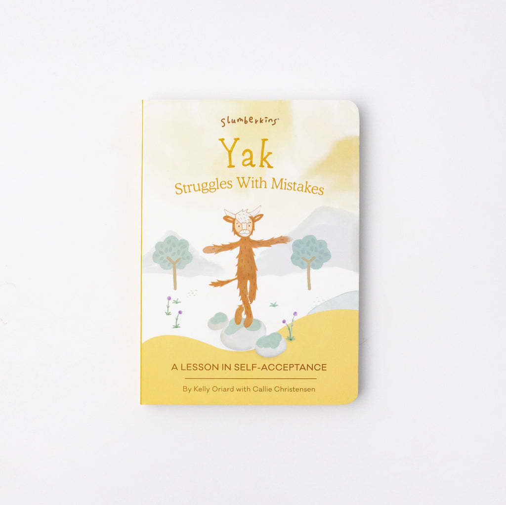 A children's book titled "Slumberkins Yak Kin + Lesson Book On Self Acceptance," featuring a cover illustration of a yak meditating in a serene landscape, highlighted by soft, pastel.