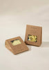 Two brown cardboard boxes of pasta, featuring transparent windows that reveal bow-tie and shell shapes, evoke the Wooden Pasta Playset. These branded boxes rest on a neutral backdrop, ideal for sparking imaginative play.