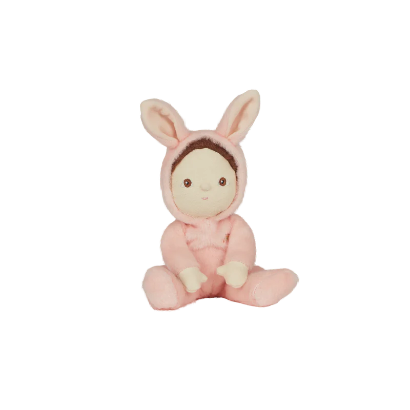 A pocket-sized Olli Ella | Dinky Dinkums - Bella Bunny plush toy wearing a pink bunny costume, seated against a black background with multi-colored horizontal stripes partially obscuring the image.