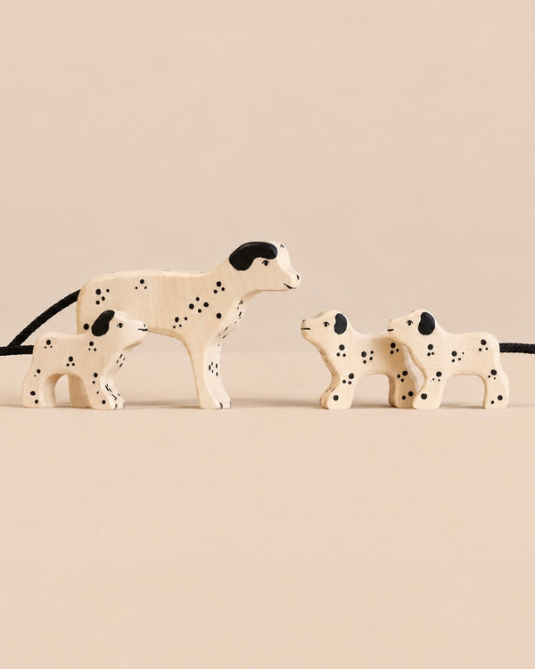 Holztiger Handmade Wooden Dalmatian Family Set featuring one adult dog and two puppies, each with painted black spots and ears.
