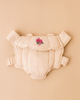 The Konges Sloejd Doll Carrier - Cameo Rose is a beige cotton carrier with padded straps and pink flower embroidery on the front, shown against a matching beige background.