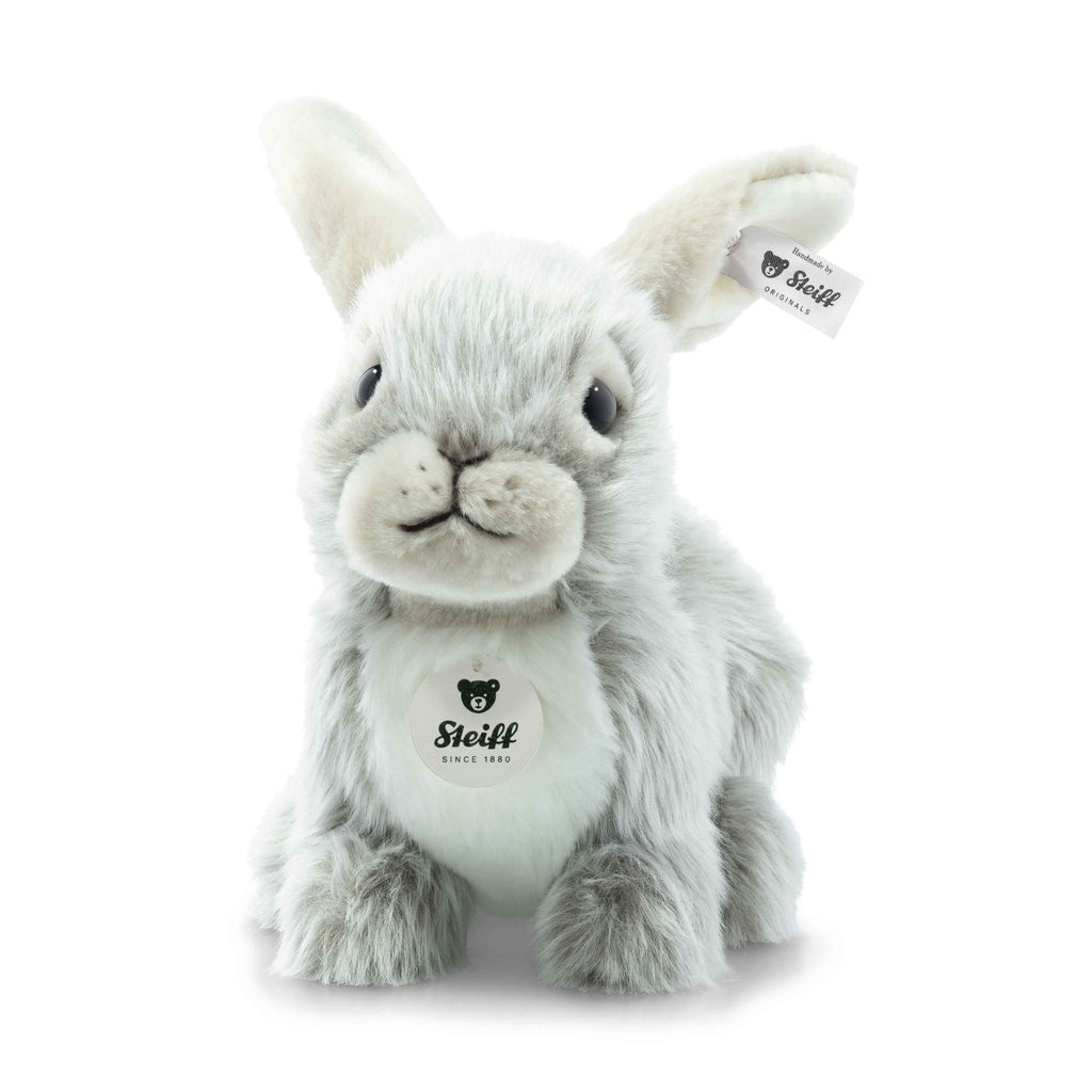 The Steiff Dormili Rabbit is a plush toy with gray and white fur, large ears, black eyes, a Steiff tag on its left ear, and the Steiff logo on its chest as it sits facing forward.