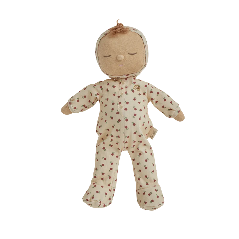 Dressed in a cream-colored onesie with a delicate floral pattern, closed eyes, and a small tuft of brown hair, the Olli Ella Dozy Dinkum - Custard Sweetheart doll makes a charming gift for newborns.