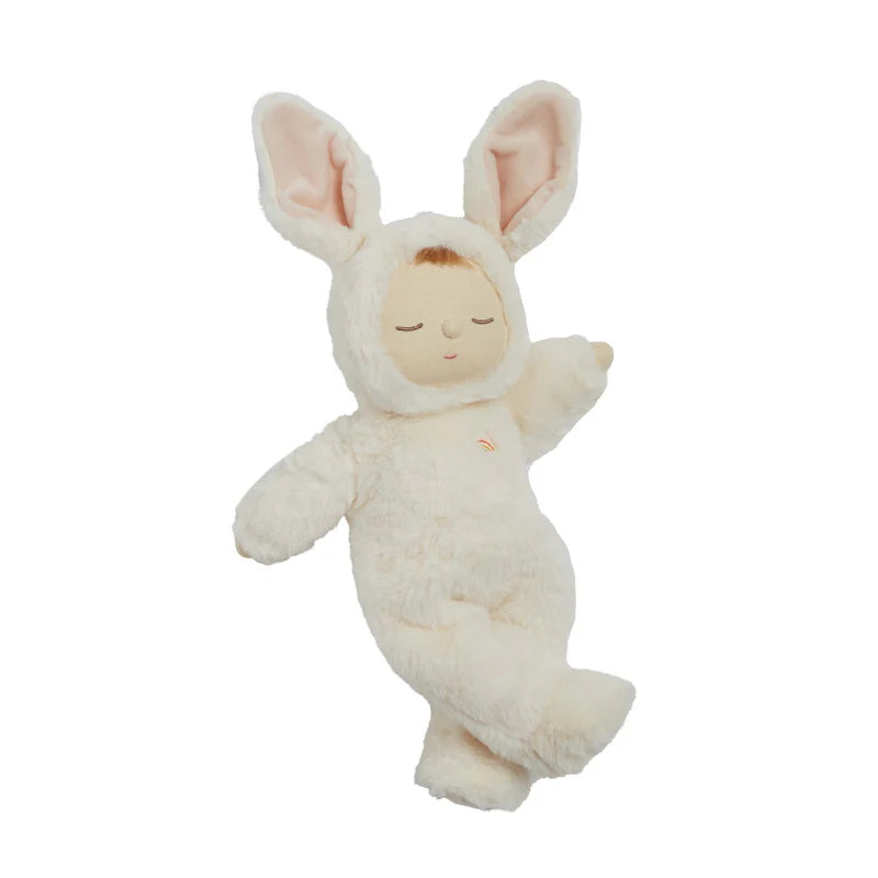 The Olli Ella Cozy Dinkum - Bunny Moppet is a collectible plush toy in a fluffy white bunny costume with pink-lined ears, closed eyes, and a peaceful look, posed with one arm raised and one leg gently bent.