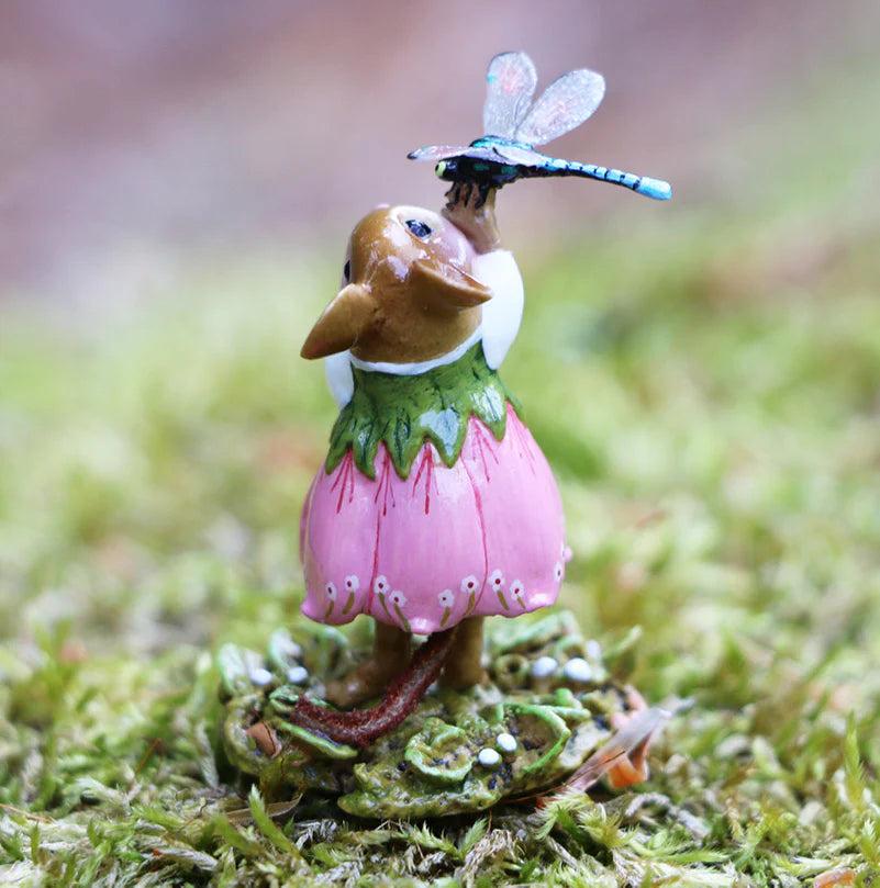 The Wee Forest Folk Tiny Collectible - Pretty Perch in Pink features a hand-sculpted mouse in a pink flower dress on moss, reaching for a blue dragonfly—a delightful addition to any miniatures collection.