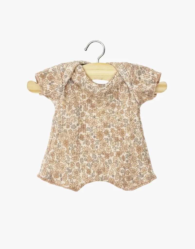 The Minikane 11" Doll Clothing Shorty Bodysuit in Ribbed Knit - Cocoa Flowers features soft, ribbed cotton with an earthy floral print and short sleeves, made in France and shown on a wooden hanger against a white background.