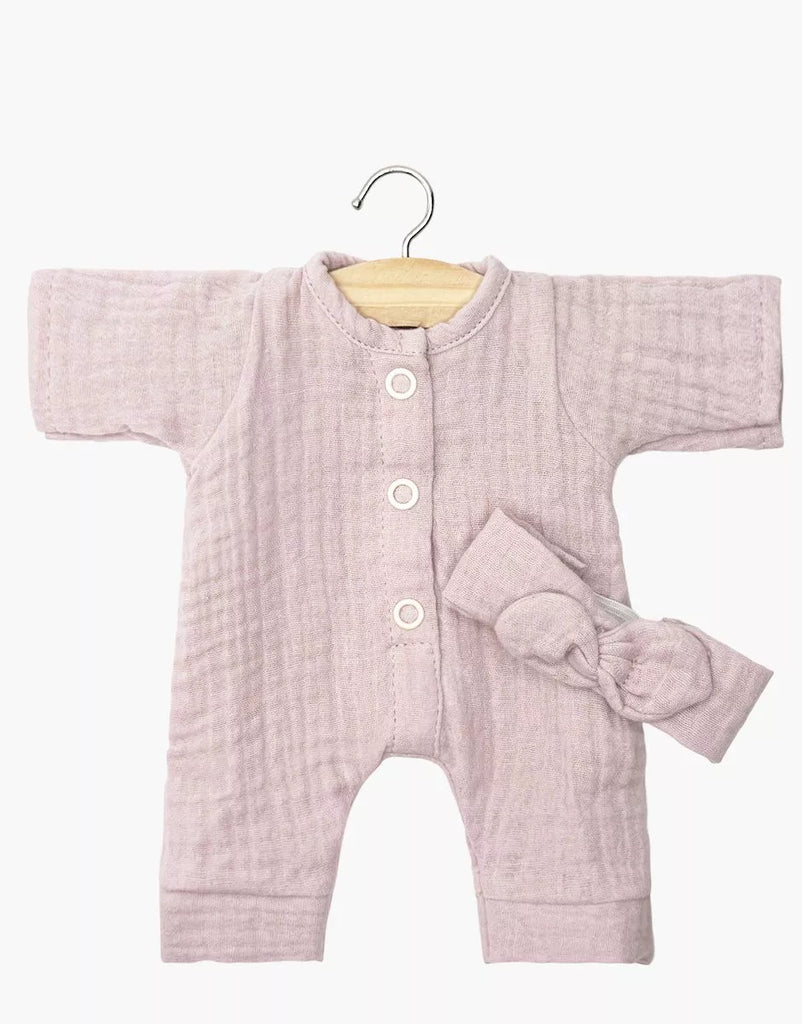 The Minikane 11" Doll Clothing set features the Lili Jumpsuit & Headband in soft orchid pink cotton gauze—long-sleeve romper with white buttons and matching bow headband, perfect for dressing up your Minikane doll.