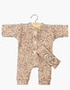 The Minikane 11" Doll Clothing | Lili Jumpsuit & Headband in Ribbed Knit - Cocoa Flowers features a pink and brown floral, long-sleeve, button-up romper with matching knotted headband. Soft ribbed texture, hand washable, and includes a wooden hanger.