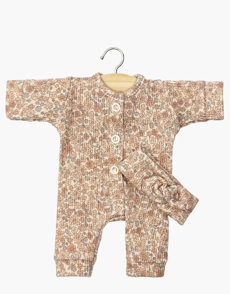 The Minikane 11" Doll Clothing | Lili Jumpsuit & Headband in Ribbed Knit - Cocoa Flowers features a pink and brown floral, long-sleeve, button-up romper with matching knotted headband. Soft ribbed texture, hand washable, and includes a wooden hanger.