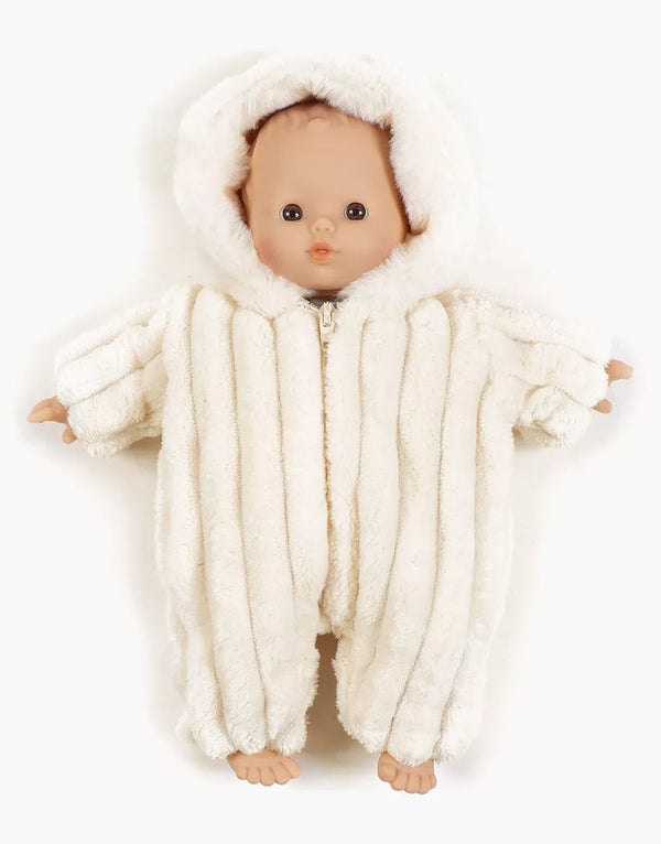 A Minikane doll lies on a white background, dressed in the Minikane 11" Minky Pilot Jumpsuit in Velvet - Off-White, a fluffy hooded outfit with a front zipper and exposed hands and feet.