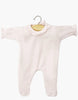 The Minikane 11" Doll Camille Onesie in pastel pink features ribbed knit cotton, lace trim, and long sleeves. Made in France, it's displayed on a wooden hanger against a white background.