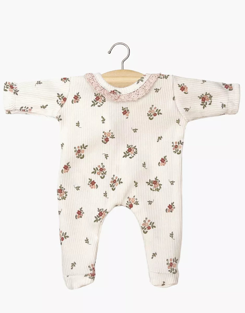 The Minikane 11" Doll Clothing | Camille Onesie in Ribbed Cotton - Pink Flowers features long sleeves, a floral print, pink lace collar, and headband. Displayed on a wooden hanger, it's perfect for 11" dolls and made in France.