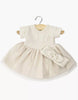 The Minikane 11" Doll Clothing | Rosana Short-Sleeved Tutu and Headband - Linen features a cream short-sleeved tutu dress with a ribbed knit bodice and a matching wide bow headband, both displayed on a wooden hanger against a white background.