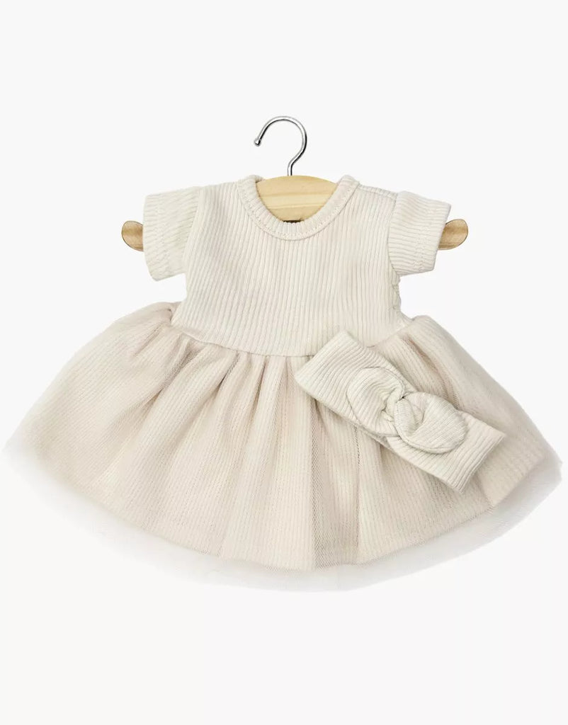 The Minikane 11" Doll Clothing | Rosana Short-Sleeved Tutu and Headband - Linen features a cream short-sleeved tutu dress with a ribbed knit bodice and a matching wide bow headband, both displayed on a wooden hanger against a white background.