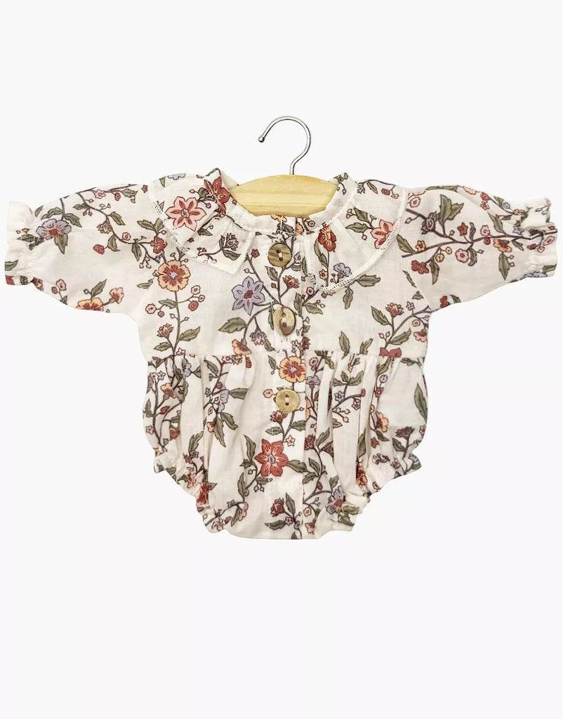 The Minikane 13" Doll Clothing | Leonore Ruffled Romper in Cotton Gauze - Gisele features a floral print in shades of pink, red, green, and purple, designed for 13 inch dolls and shown on a wooden hanger against a white background.
