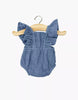 The Lou Retro Romper in blue denim cotton gauze is shown on a wooden hanger against a white background—sized perfectly for 13" dolls or Minikane dolls.