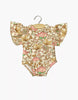 Minikane 13" Doll Clothing | Ondine Bodysuit in Jersey Cotton - Indian Dew: cream onesie with ruffled short sleeves and a pink, green, & gold floral print, fits 13" dolls like Minikane Gordis. Shown on a wooden hanger against a white backdrop.