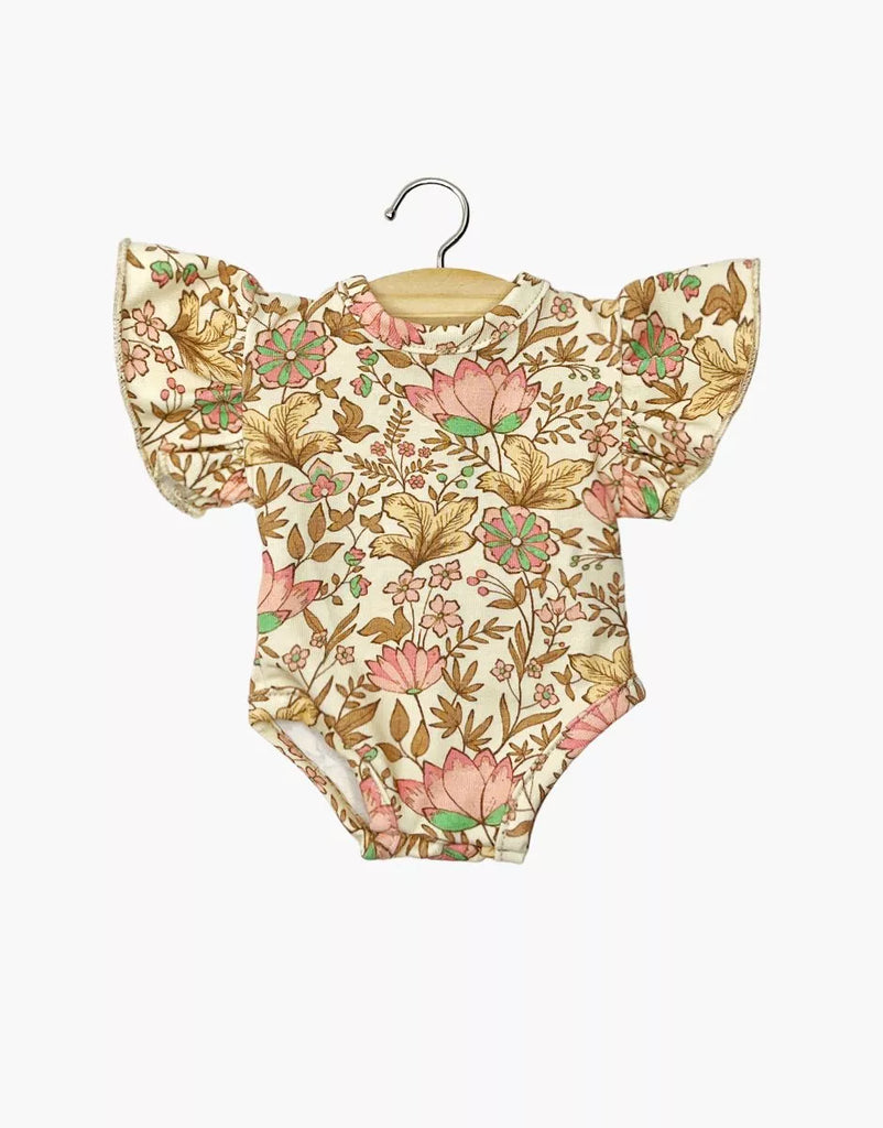 Minikane 13" Doll Clothing | Ondine Bodysuit in Jersey Cotton - Indian Dew: cream onesie with ruffled short sleeves and a pink, green, & gold floral print, fits 13" dolls like Minikane Gordis. Shown on a wooden hanger against a white backdrop.
