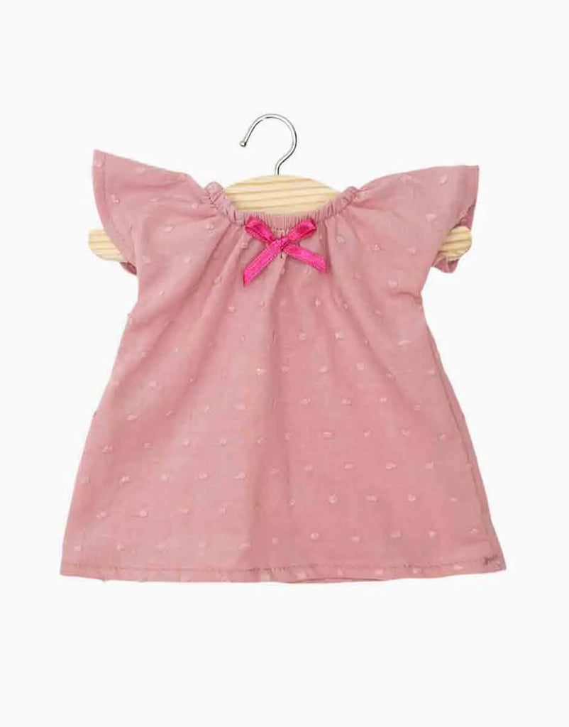Minikane 13″ Doll Clothing | Mary Nightgown in Polka Dot Cotton - Tea Pink, a dusty pink nightgown with flutter sleeves, a textured dotted pattern, and a dark pink bow at the neckline, hanging on a wooden hanger.