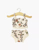 The Minikane 13" Doll Clothing | Les P'tits Basiques, 2-Piece Set in Jersey - Gisele features a floral-patterned cream tank top and matching underwear, displayed on a wooden hanger. Made in France for 13" or Minikane dolls.