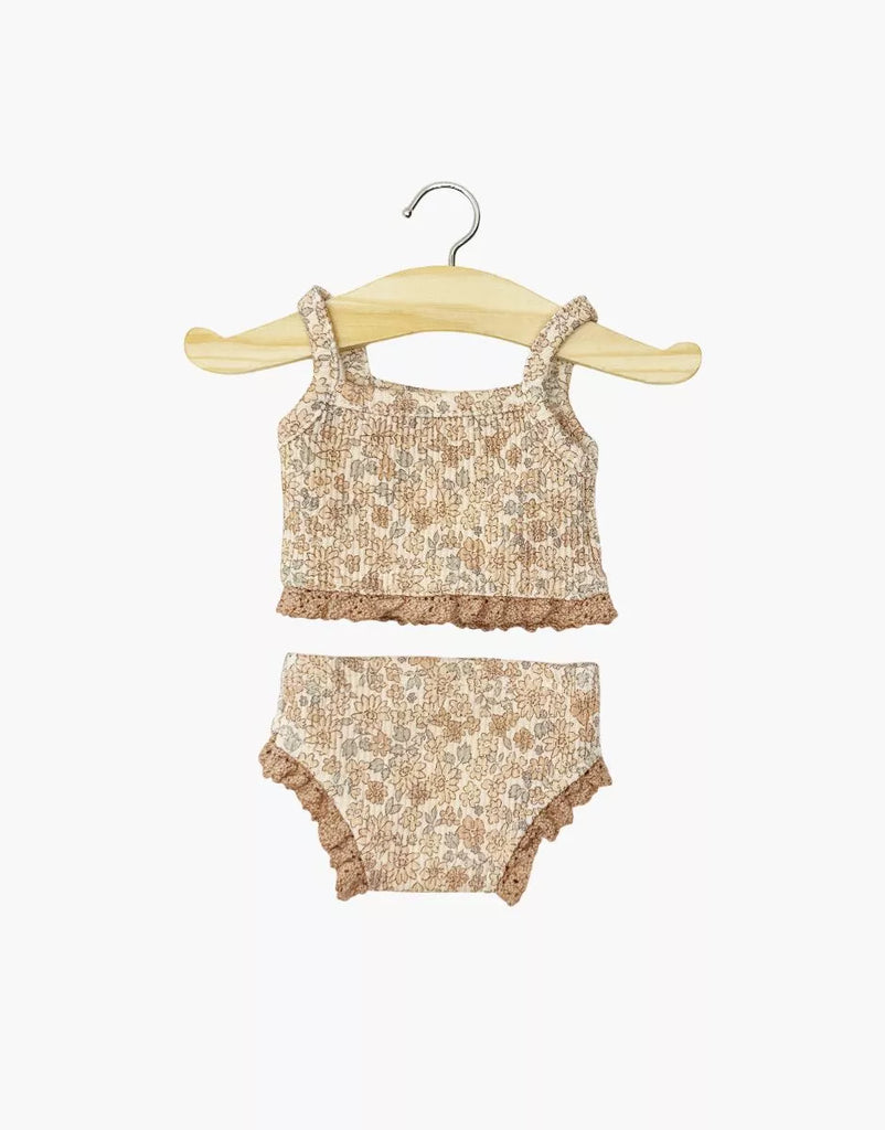 The Minikane Doll Clothing | Les P'tits Basiques 2-Piece Set in Jersey - Cocoa Flowers features a beige and light brown sleeveless top and matching bottoms with floral patterns, designed for Gordis dolls, shown on a wooden hanger against a white background.