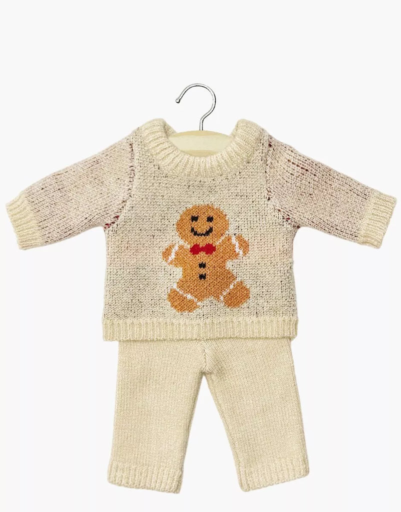 The Minikane 13" Doll Clothing Christmas Gingerbread Two-Piece Knit Set includes a cream-colored long-sleeve sweater with a gingerbread man and matching pants—an ideal festive outfit for Minikane dolls or similar 13-inch doll collections.