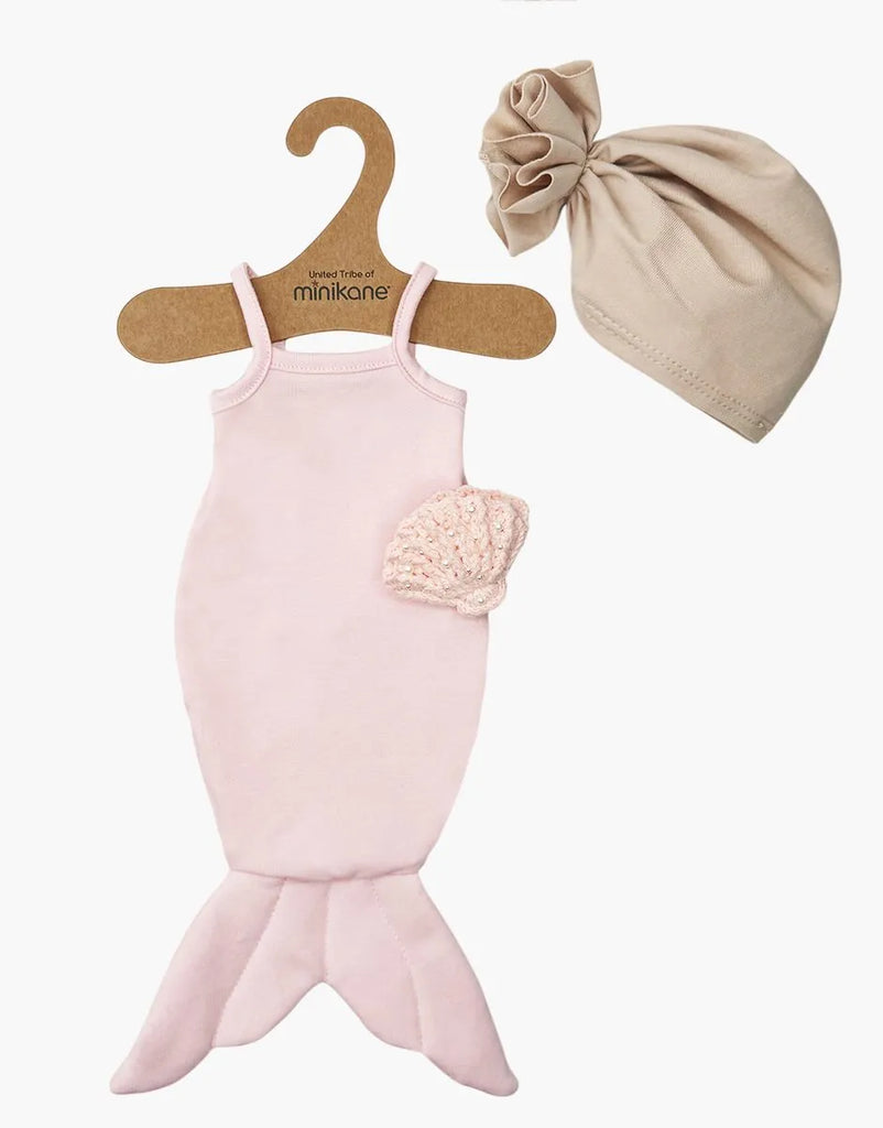 The Minikane 13" Doll Clothing | Mermaid Costume & Pink Pearl Seashell Set features a light pink mermaid outfit with shoulder straps, a knitted seashell top, and a beige head turban—perfect accessories for 13 inch dolls.