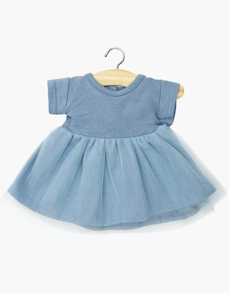 The Minikane Doll Clothing | Rosana Short Sleeve Tutu in cobalt blue is a light blue short-sleeved dress with a full tulle skirt, made for 13-inch dolls like Minikane, shown on a wooden hanger against a white background.