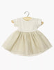 The Minikane Doll Clothing | Rosana Short Sleeve Tutu - Gold features a cream ribbed knit top and a shimmery gold tulle skirt, perfect for 13-inch dolls. Displayed on a small wooden hanger against a white background.