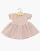 The Minikane Doll Clothing | Rosana Short Sleeve Tutu in Petal Pink features a knit bodice, ribbed short sleeves, and a soft tulle skirt, perfectly sized for Minikane or other 13" dolls, shown on a wooden hanger against a white background.
