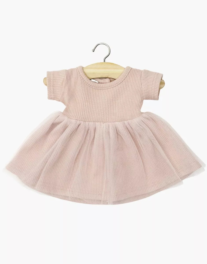 The Minikane Doll Clothing | Rosana Short Sleeve Tutu in Petal Pink features a knit bodice, ribbed short sleeves, and a soft tulle skirt, perfectly sized for Minikane or other 13" dolls, shown on a wooden hanger against a white background.