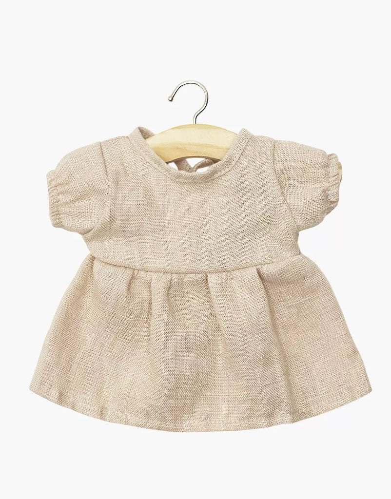 A nude linen Faustine dress with balloon sleeves for 11" Minikane dolls, displayed on a wooden hanger against a white background—ideal for dressing your Minikane Babies doll in style.