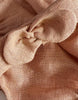 Close-up of the Minikane Doll Clothing Clara Romper & Headband in washed linen (Hazelnut), made in France, highlighting the textured fabric twisted into a loose knot to showcase its weave and soft folds.