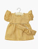 A small, short-sleeved oatmeal Daisy dress with ruffled sleeves and a matching headband in washed linen for Minikane dolls, displayed on a wooden hanger against a plain white background.