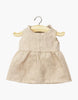The Minikane 13" Doll Clothing Sleeveless Faustine Dress in Washed Linen - Nude is displayed on a wooden hanger against a white background.