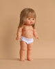 The Minikane Standing Doll (14") - Zoelie features light skin, straight blonde hair with bangs, and white underwear. Anatomically correct and made in Spain, Zoelie stands upright against a plain beige background. Clothing sold separately.