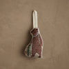 The Coral & Tusk Bear with Tinsel Ornament is a small fabric bear ornament with a cream hanging loop, simple stitched brown bear and green pine tree—ideal as a woodland Christmas decoration or mini tree ornament.