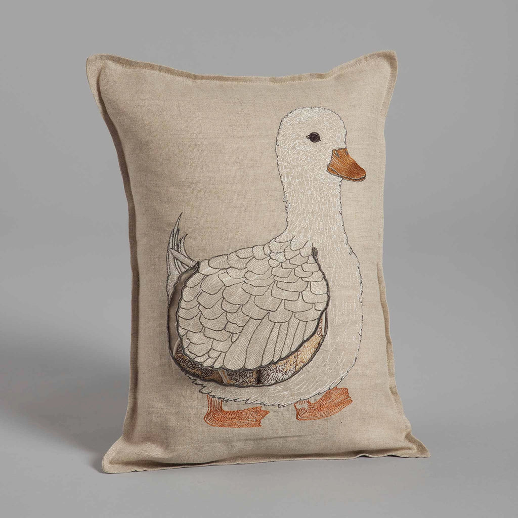 Decorative Coral & Tusk Mama Duck Pocket Pillow with a beige linen fabric featuring an embroidered Mama Duck in shades of white and gray, standing upright with orange feet and beak. This pocket pillow includes removable ducklings. It is positioned